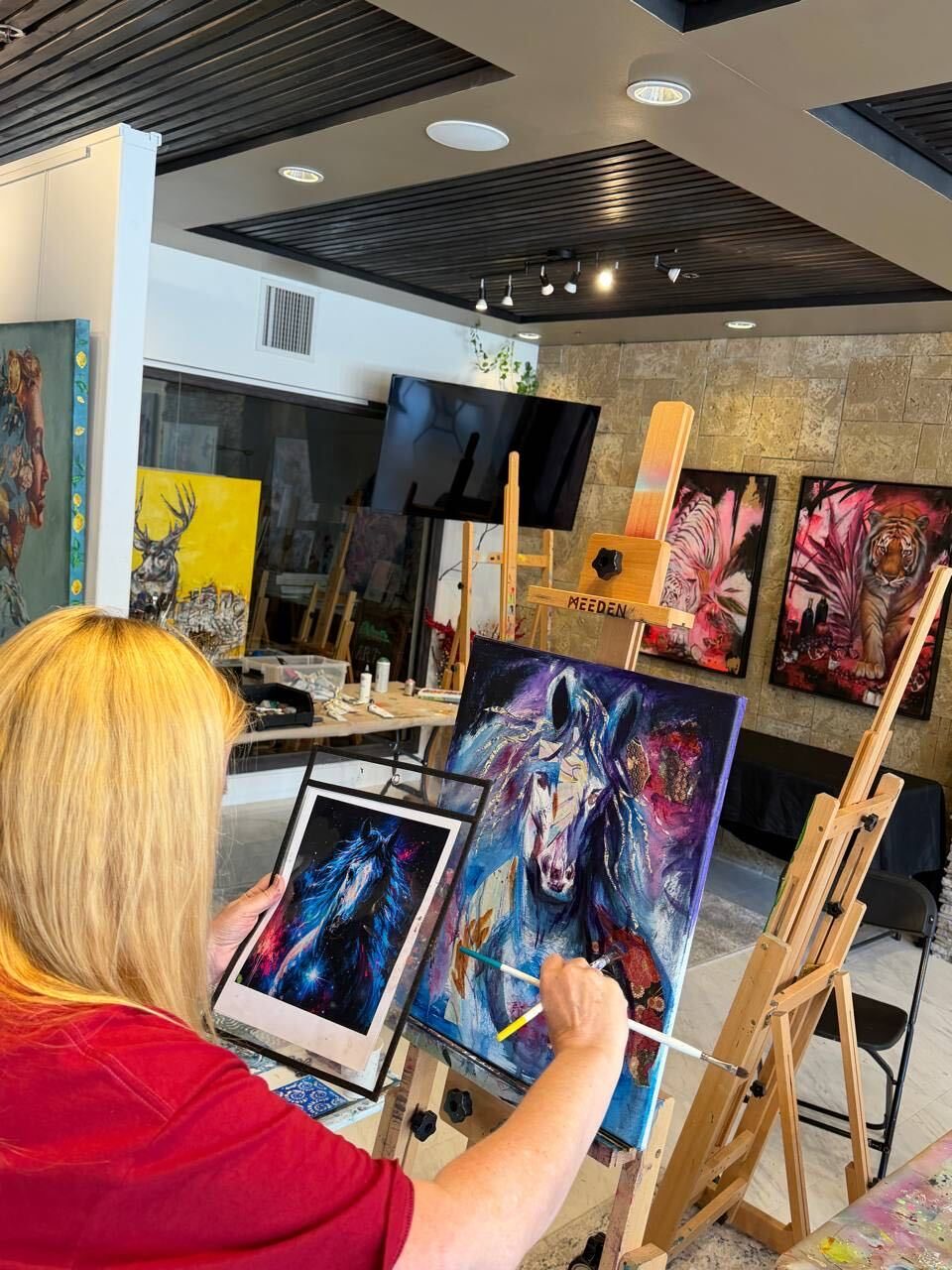 Working from a reference at the easel.
