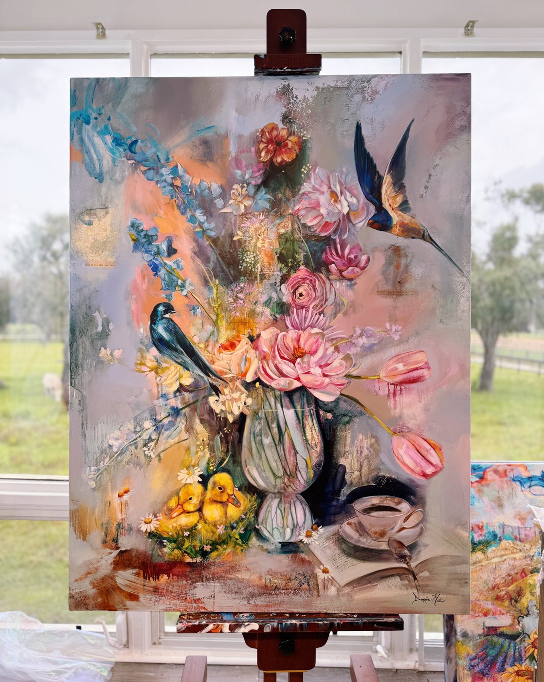 Floral still life painting in progress on the easel, with peonies, tulips and birds woven through soft, light-filled layers