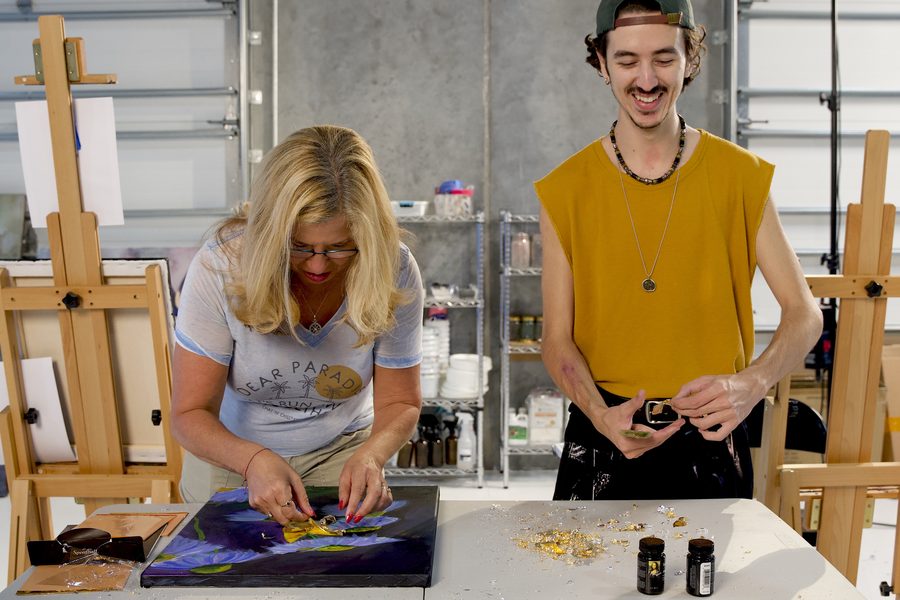 Instructor and student smiling at their easels during the workshop