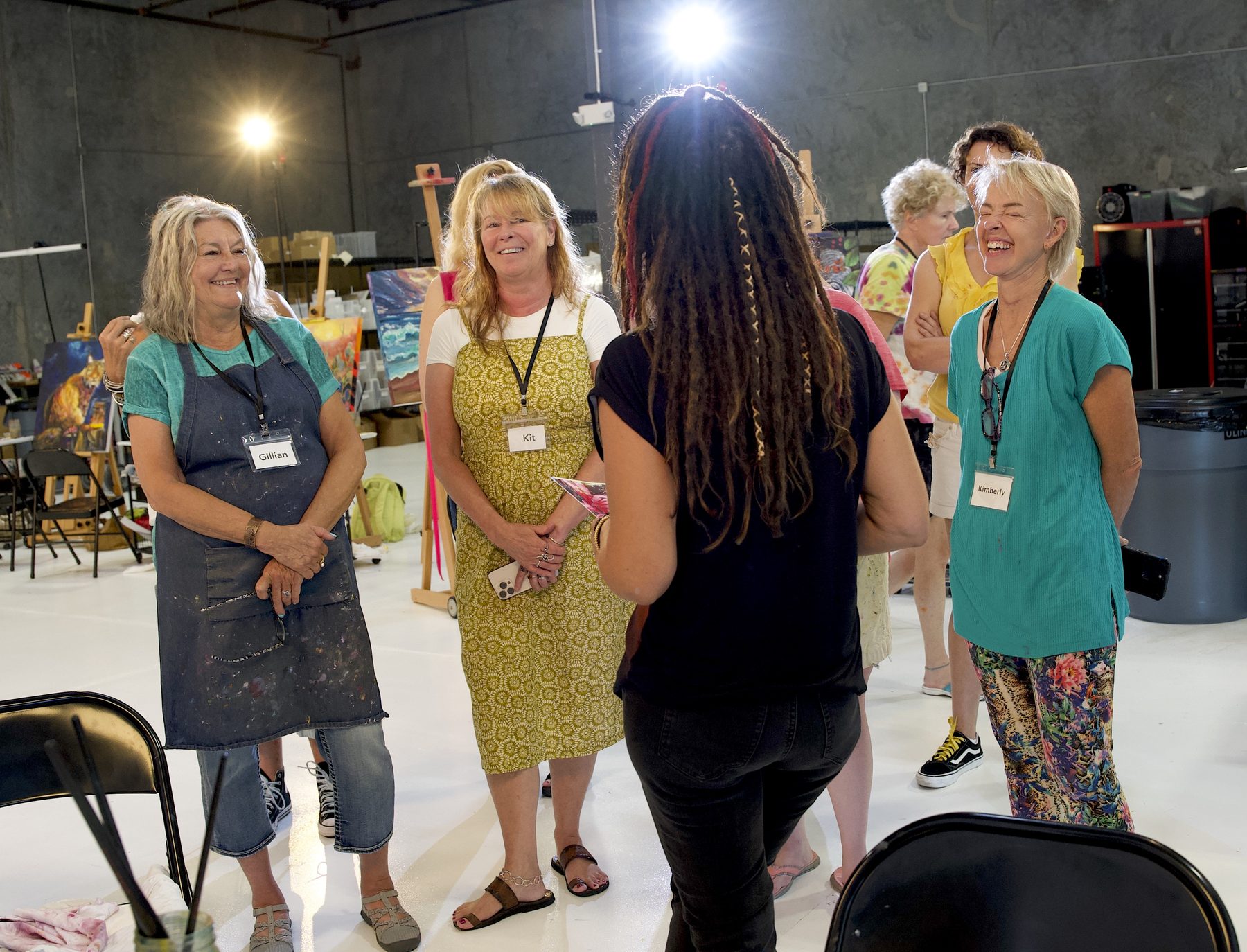 Students laughing together at a Milan Art Institute workshop in the Sarasota studio