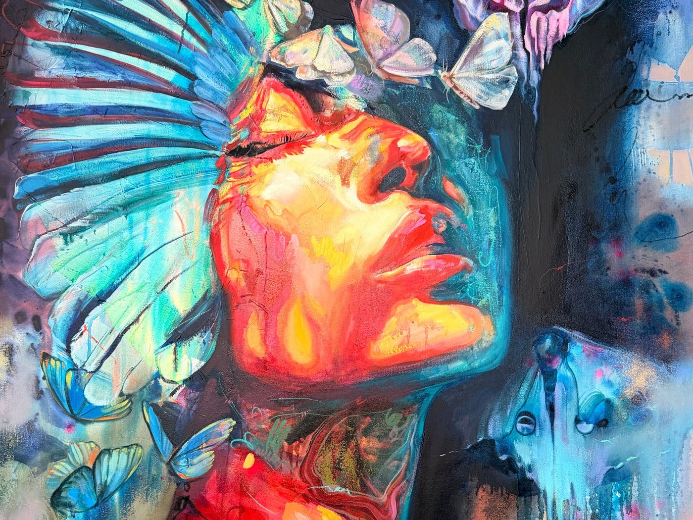 Detail of an oil painting by Dimitra Milan: a woman's upturned face lit in red and gold, a blue wing across one side and pale moths above her